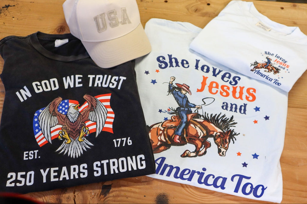 Two t-shirts graphics on a wooden surface.