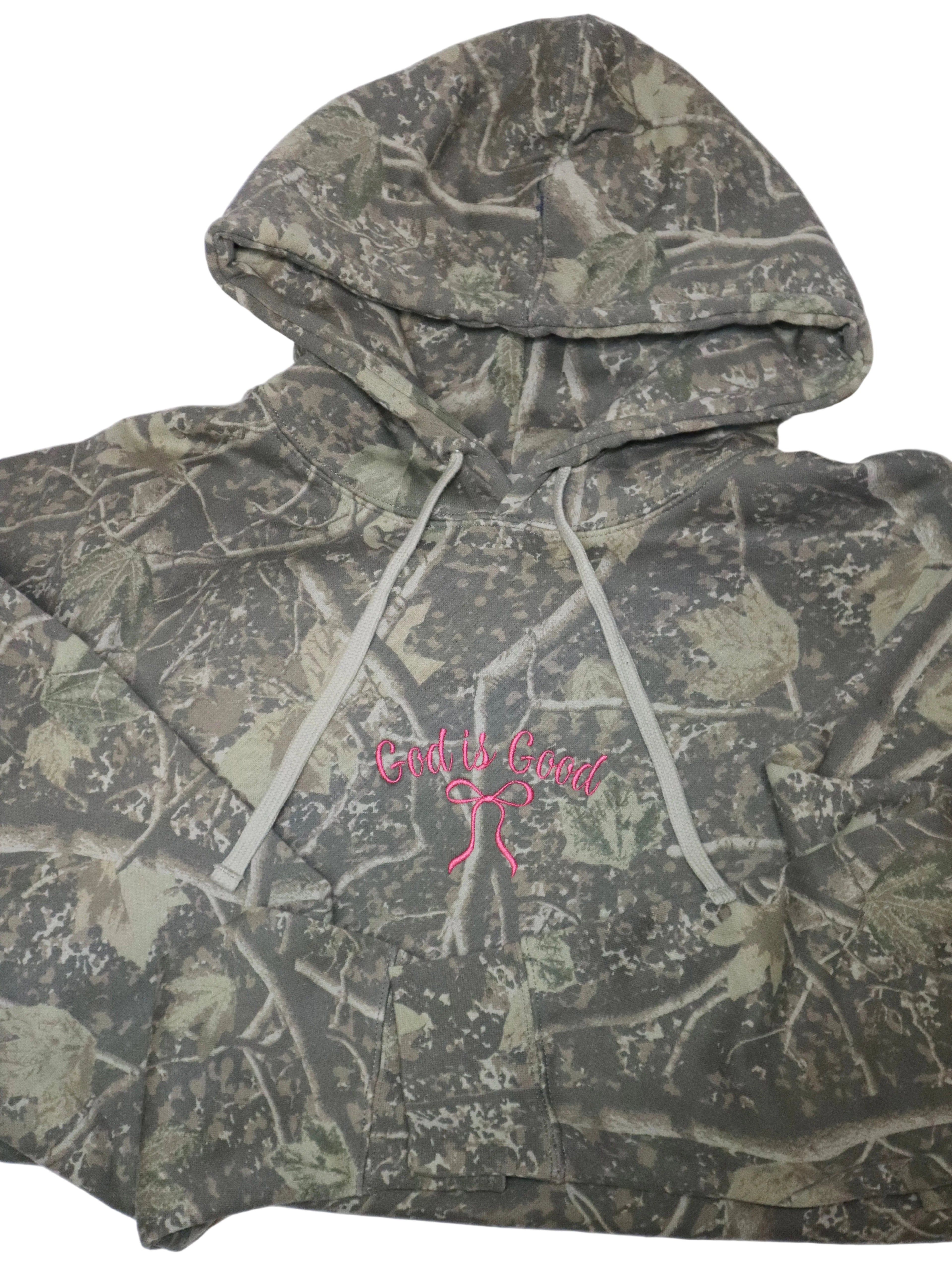 Camouflage hoodie with a pink logo on a white background