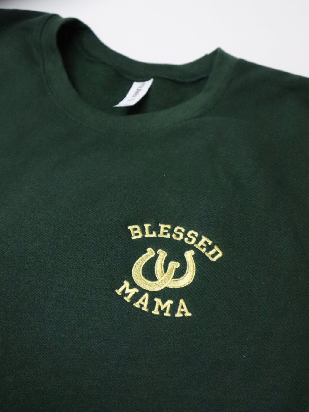Green sweatshirt with 'Blessed Mama' text and design on a white background