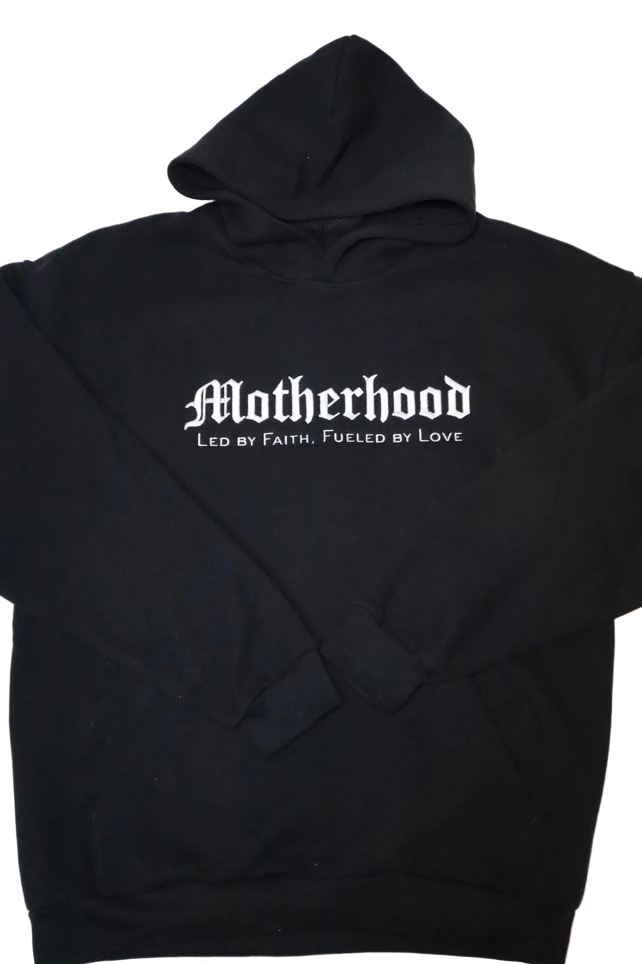 Black hoodie with 'Motherhood Led by Faith, Fueled by Love' text on a white background